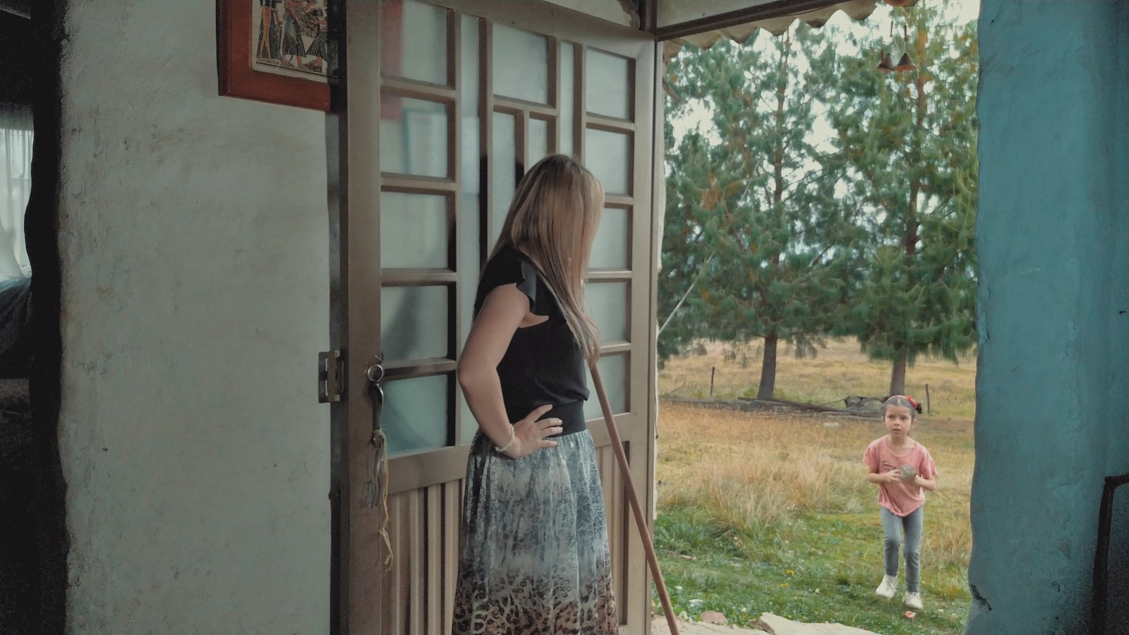 Lucía walks into the forest vegetation